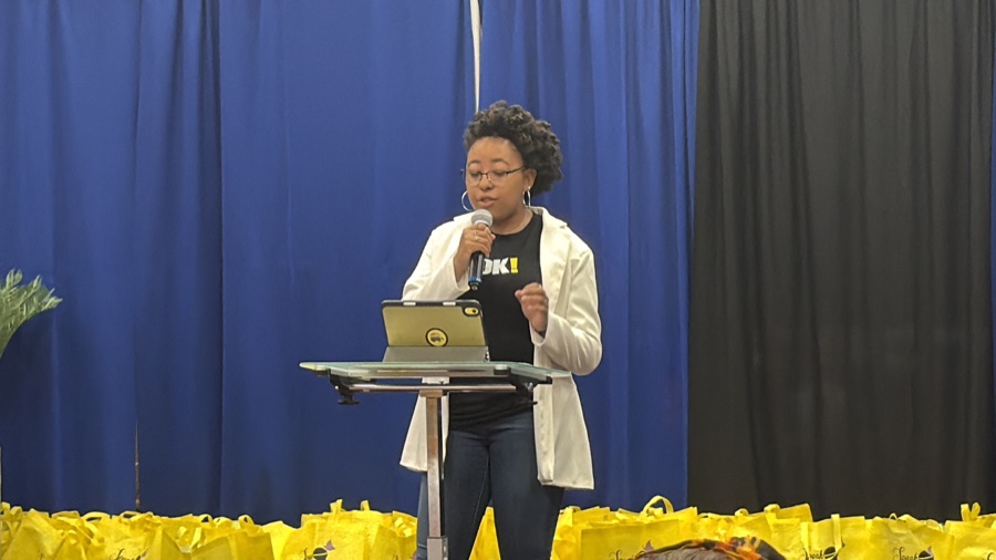 Speaker addressing the audience at the Why Wait? Youth Event
